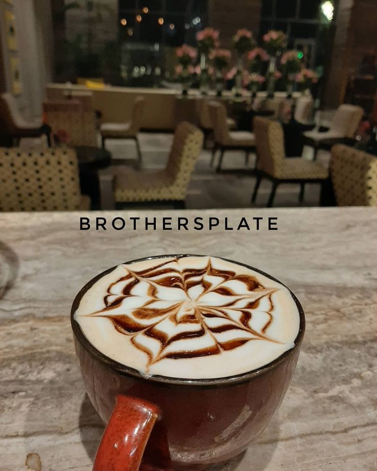 A cup of latte with the words brotherplate on it.