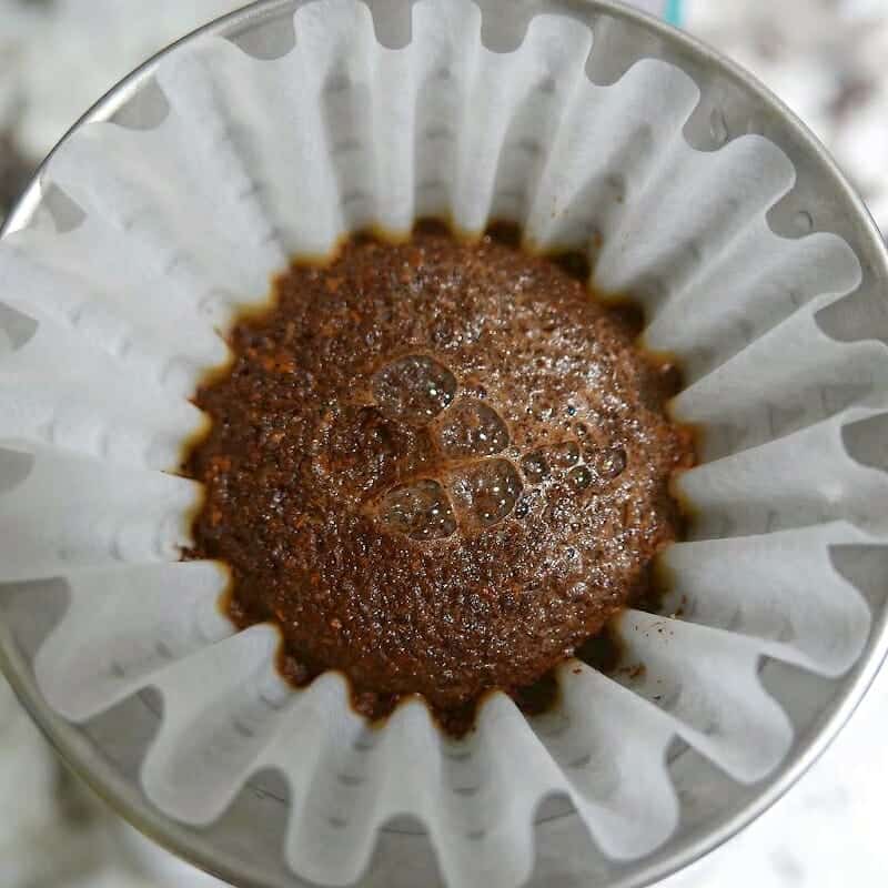 A coffee filter with a coffee in it.
