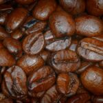 A close up image of a pile of coffee beans.
