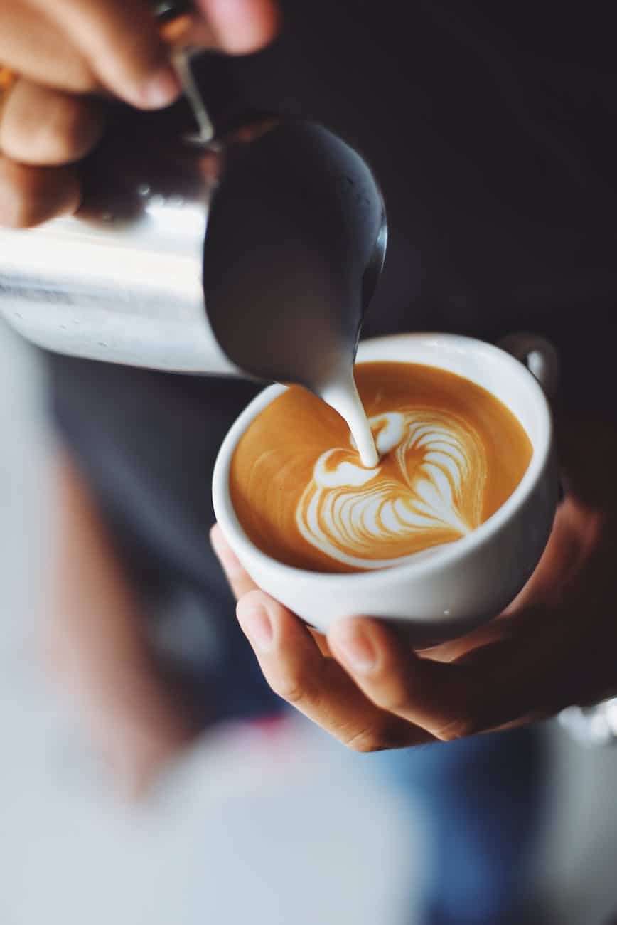woman pouring cappuccino