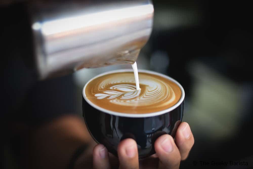 A person pouring a coffee into a cup.