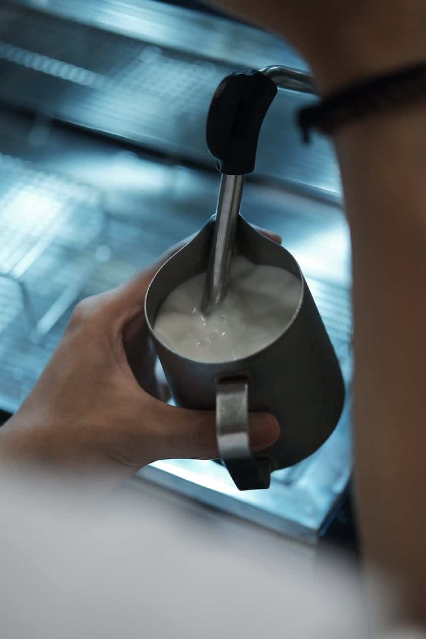 a person holding a cup of milk