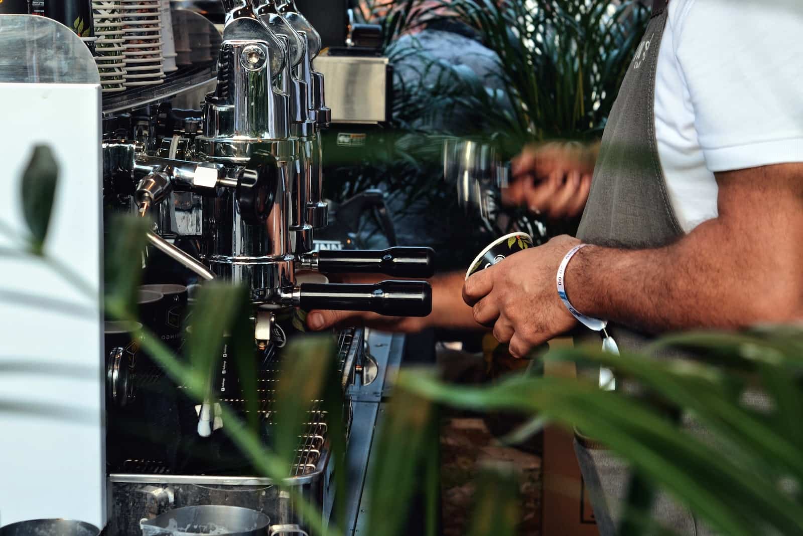 Closeup of Baristas Using Coffee Machines