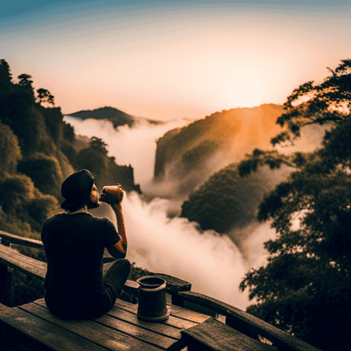 An image showcasing a serene setting with a person sipping Yogi Detox Tea at sunrise, surrounded by lush greenery and a gentle mist rising from a nearby waterfall
