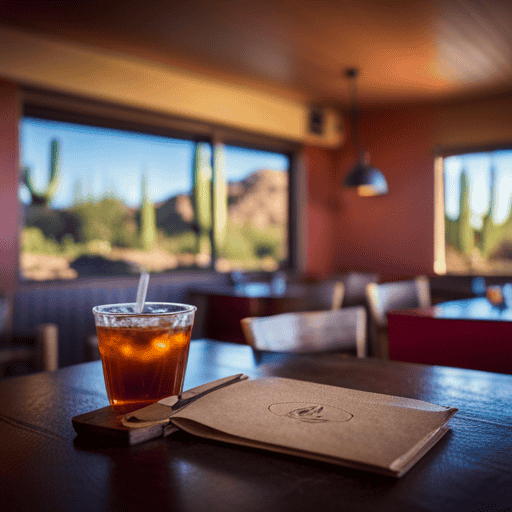 An image of a vibrant, sun-kissed Arizona desert landscape, featuring a cozy rustic cafe nestled amidst towering saguaro cacti, serving refreshing glasses of aromatic herbal tea, enticing visitors to indulge in local flavors