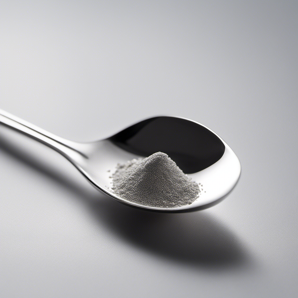An image depicting a sleek silver teaspoon delicately holding 1