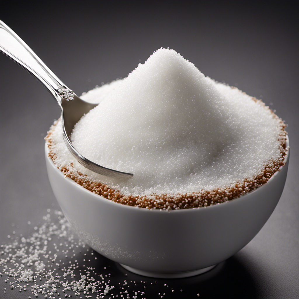 An image displaying a tablespoon overflowing with granulated sugar, while adjacent to it, a teaspoon is filled with the exact amount of sugar needed to equal one tablespoon, emphasizing the conversion