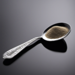 An image showcasing a teaspoon filled with precisely measured 11 milligrams of a substance