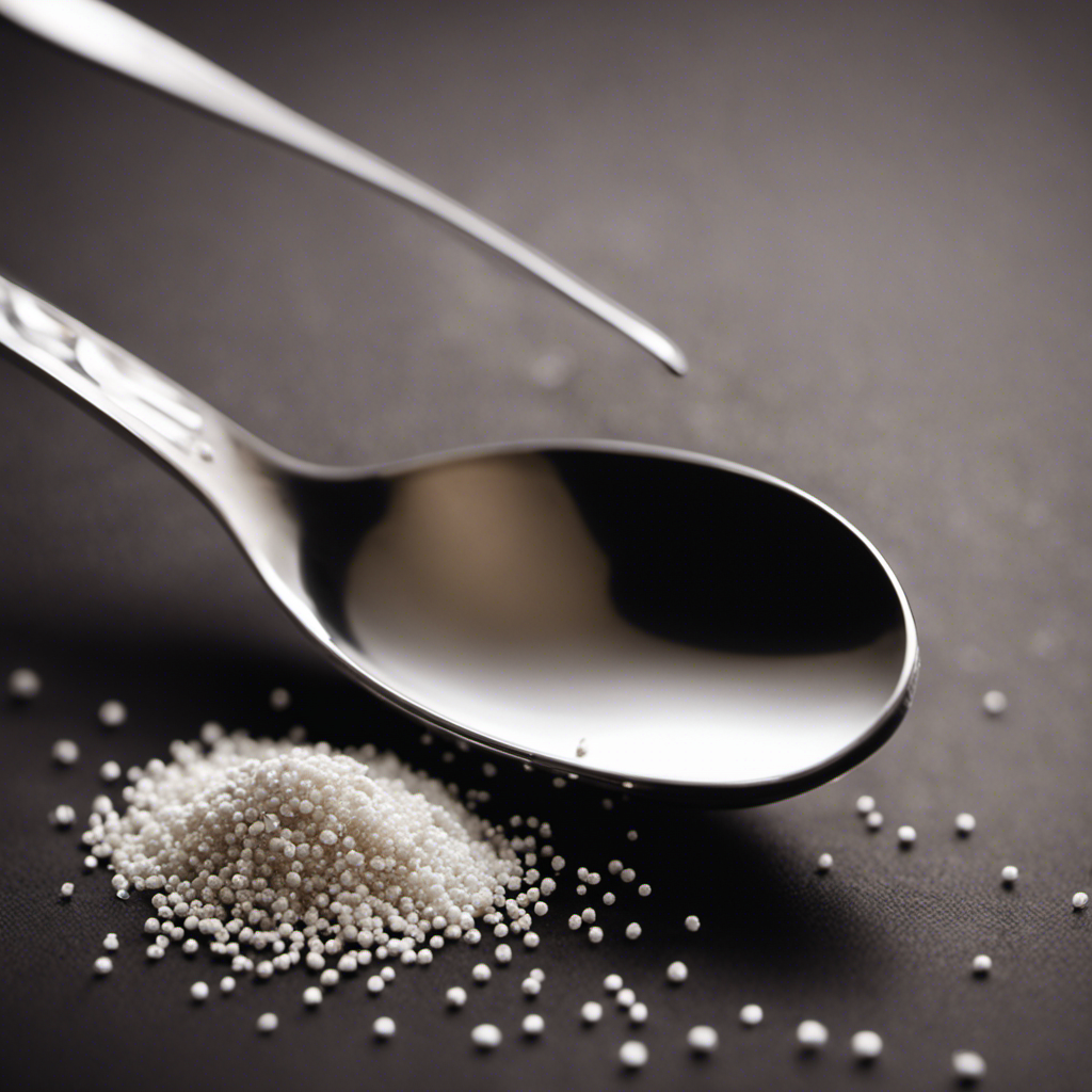 An image capturing the essence of 18 grams in teaspoons, showcasing a delicate silver teaspoon brimming with fine white granules, perfectly leveled, against a backdrop of a kitchen counter