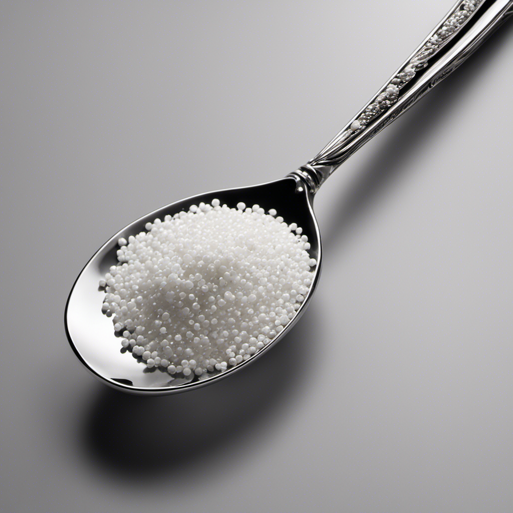 An image depicting a silver teaspoon filled with tiny white granules, representing 200 milligrams