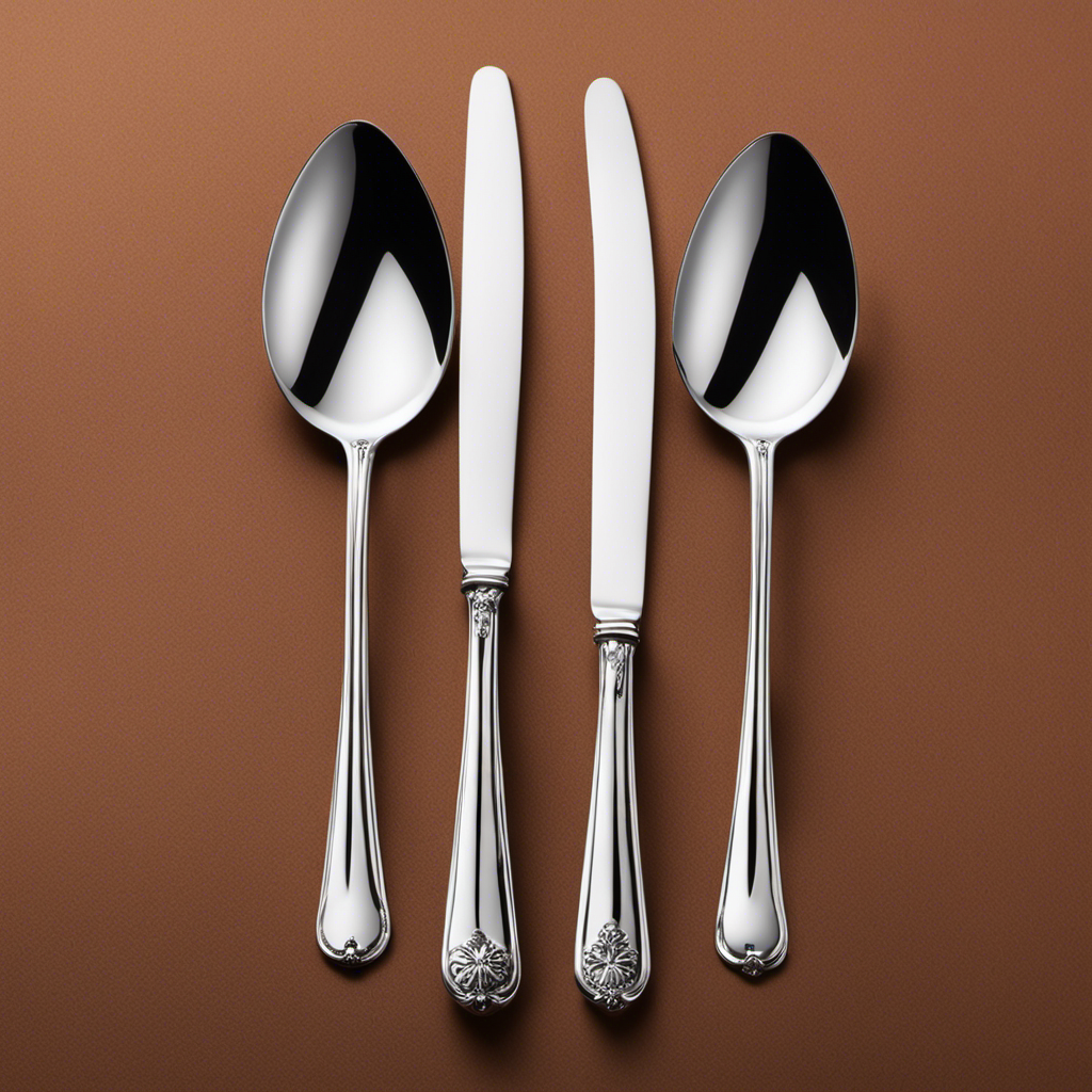 An image showcasing three delicate, shiny teaspoons artfully arranged beside a larger, gleaming tablespoon