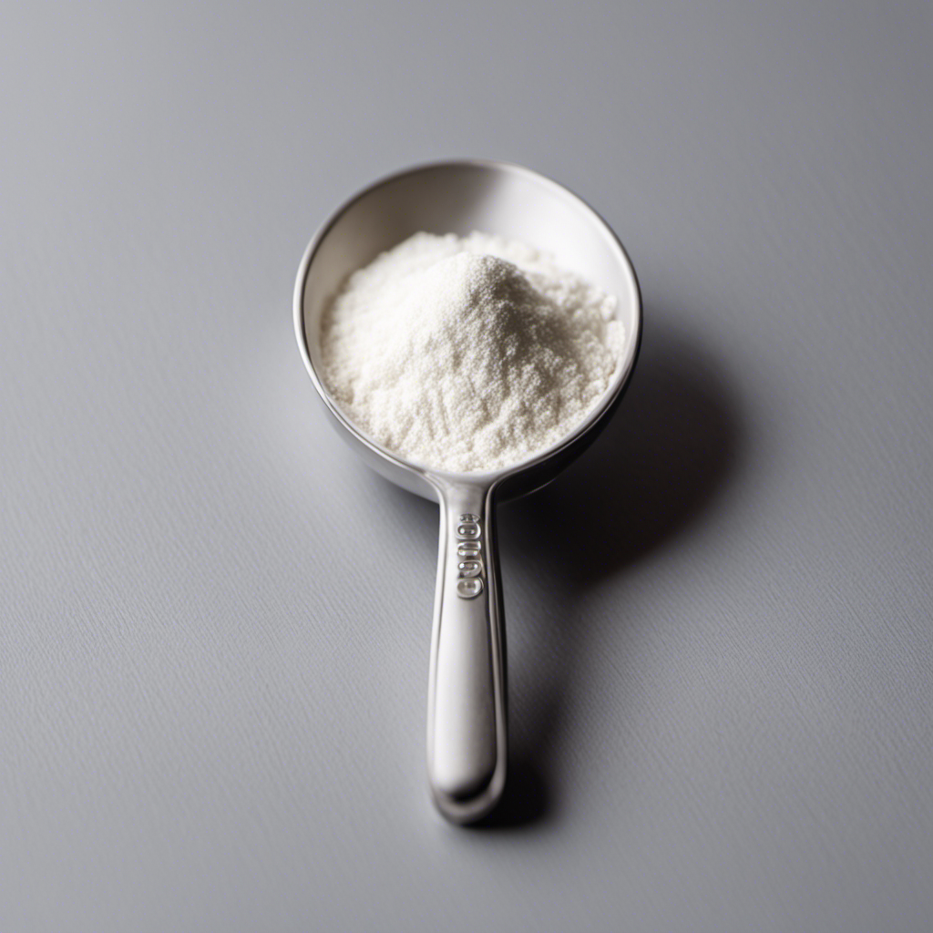 An image showcasing a small measuring spoon filled with precisely 4 grams of fine white creatine powder, sitting next to a teaspoon filled with an equal amount, allowing readers to visually compare the measurements
