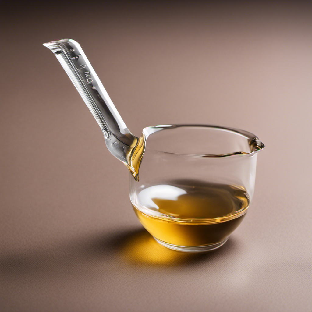 An image showing a clear, glass measuring spoon filled with precisely 5ml of liquid, positioned next to a teaspoon, highlighting the exact quantity difference between the two measurements