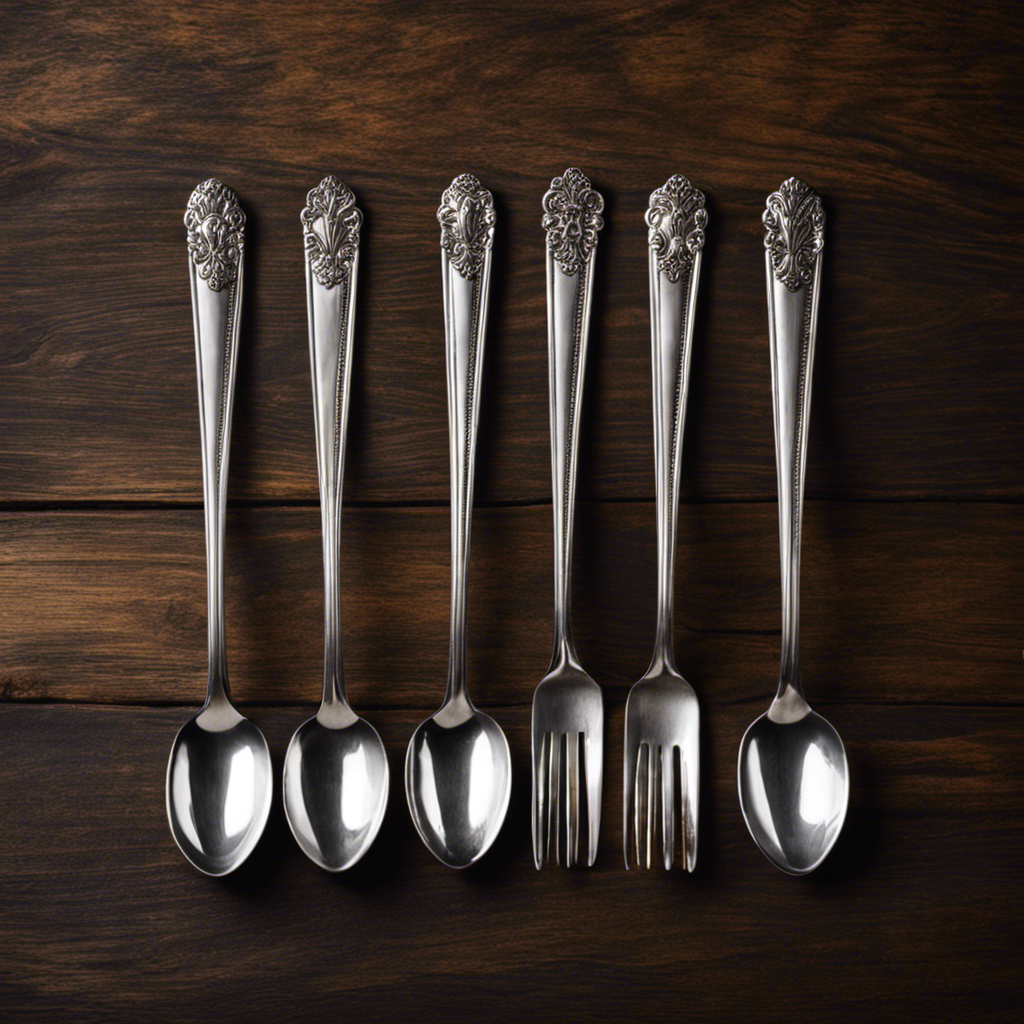 An image of a vintage silver teaspoon set, arranged neatly in a row on a rustic wooden table