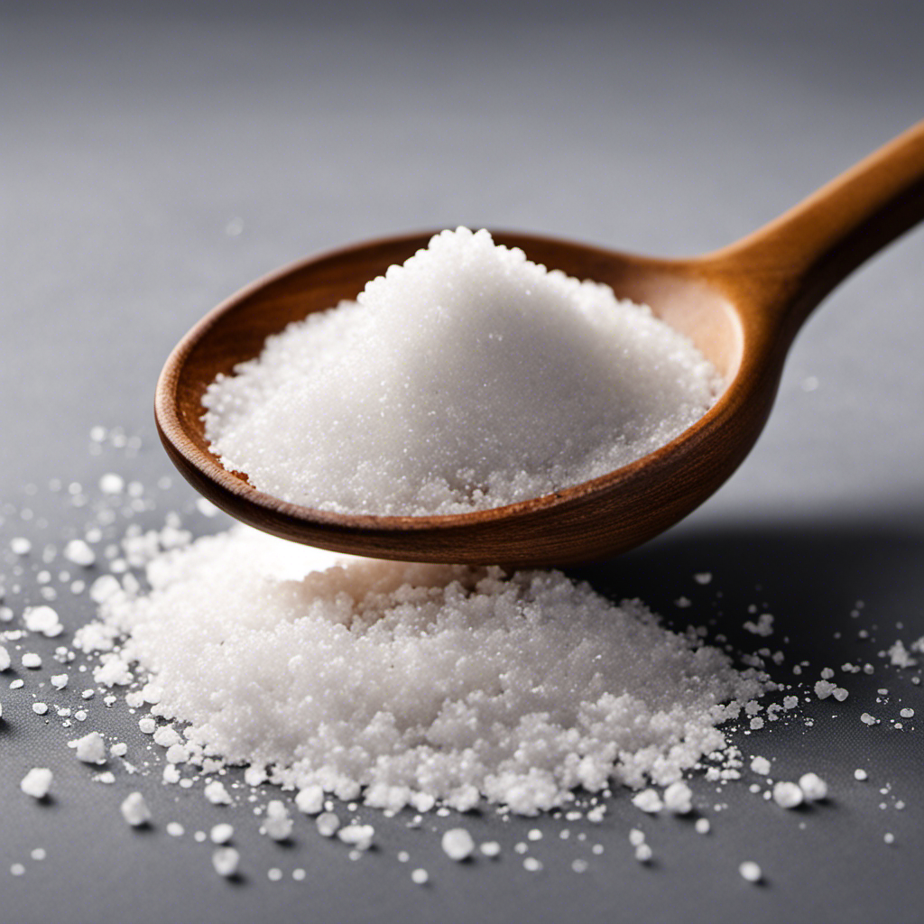 An image showcasing a single white packet of salt, ripped open at the top, pouring its contents into a small teaspoon