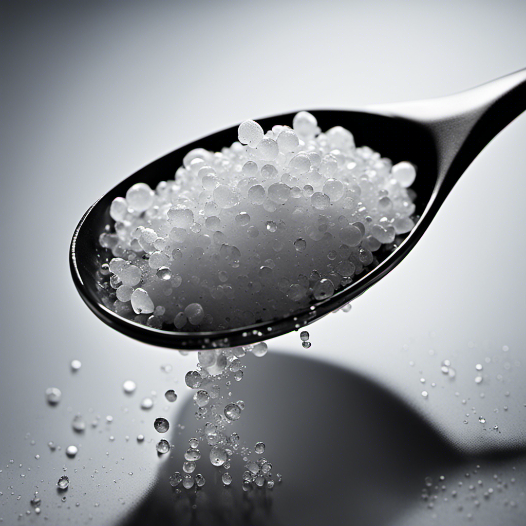 An image showcasing a transparent teaspoon filled with salt granules, with a droplet of water forming on top