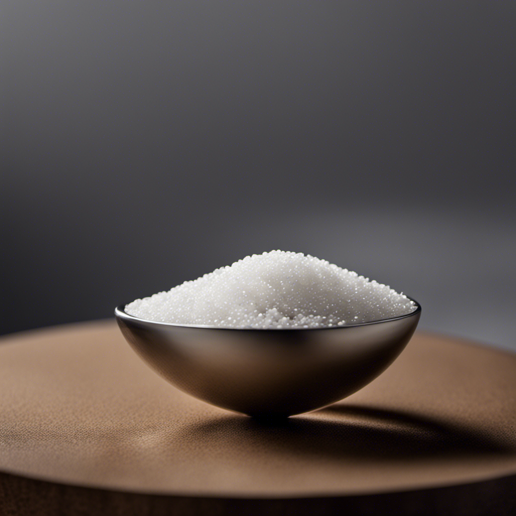An image showcasing a delicate, silver teaspoon, gracefully balancing a perfect mound of fine, white salt grains atop its curved surface, evoking curiosity about the equivalence of 1 gram of salt
