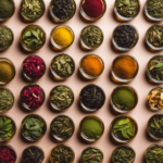 An image showcasing various types of tea leaves, from green and black to oolong and jasmine, in vibrant hues