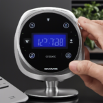 An image showing hands holding an Ecovacs remote, with one hand pressing the "Menu" button, while the other hand adjusts the time using the arrow keys