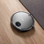 An image showcasing the LYNKBEY M20 Pro, a sleek and modern robotic vacuum, effortlessly gliding across a meticulously clean living room, its advanced sensors and powerful suction leaving no dirt or dust behind